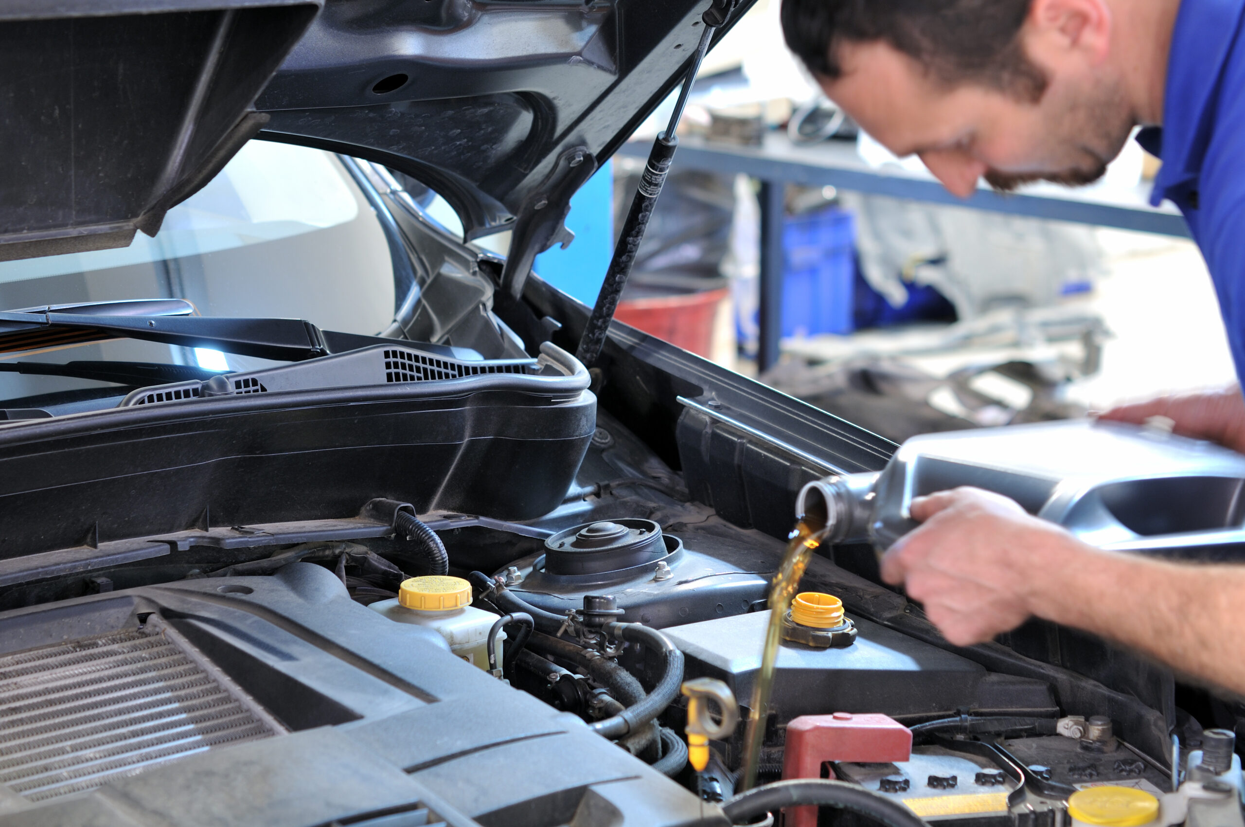 man changing car oil