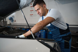 Young man doing car repairs 
