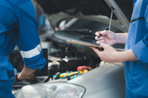 mechanics inspect car hood