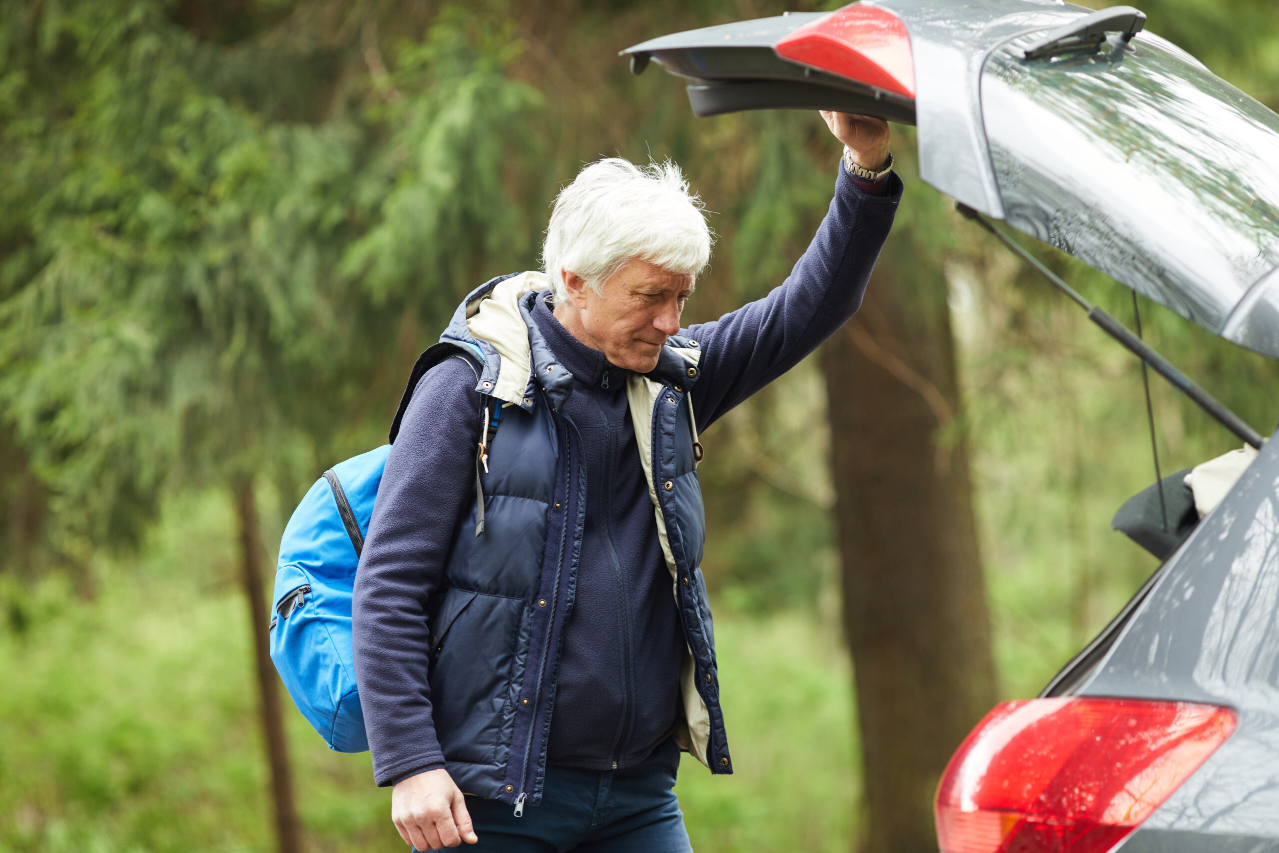 Active Senior Man by hatchback